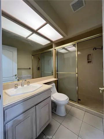 a bathroom with a double vanity sink toilet and shower