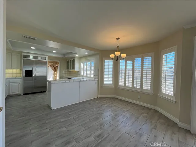 a view of a kitchen with a sink cabinets and wooden floor