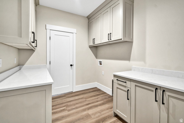 840 South Jones Road Monroe, UT 84754 - Photo 11 of 52 Light-toned cabinetry with matte black hardware, white countertops with backsplash, and wood-finish flooring