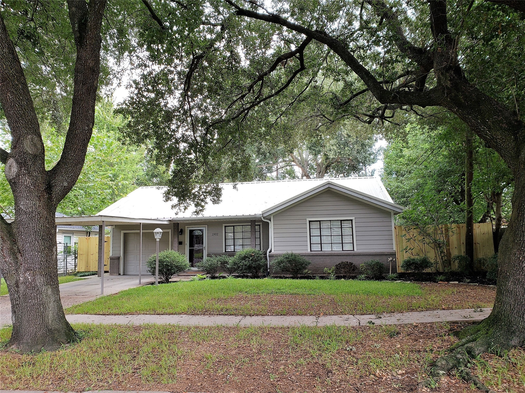a front view of a house with a yard and porch