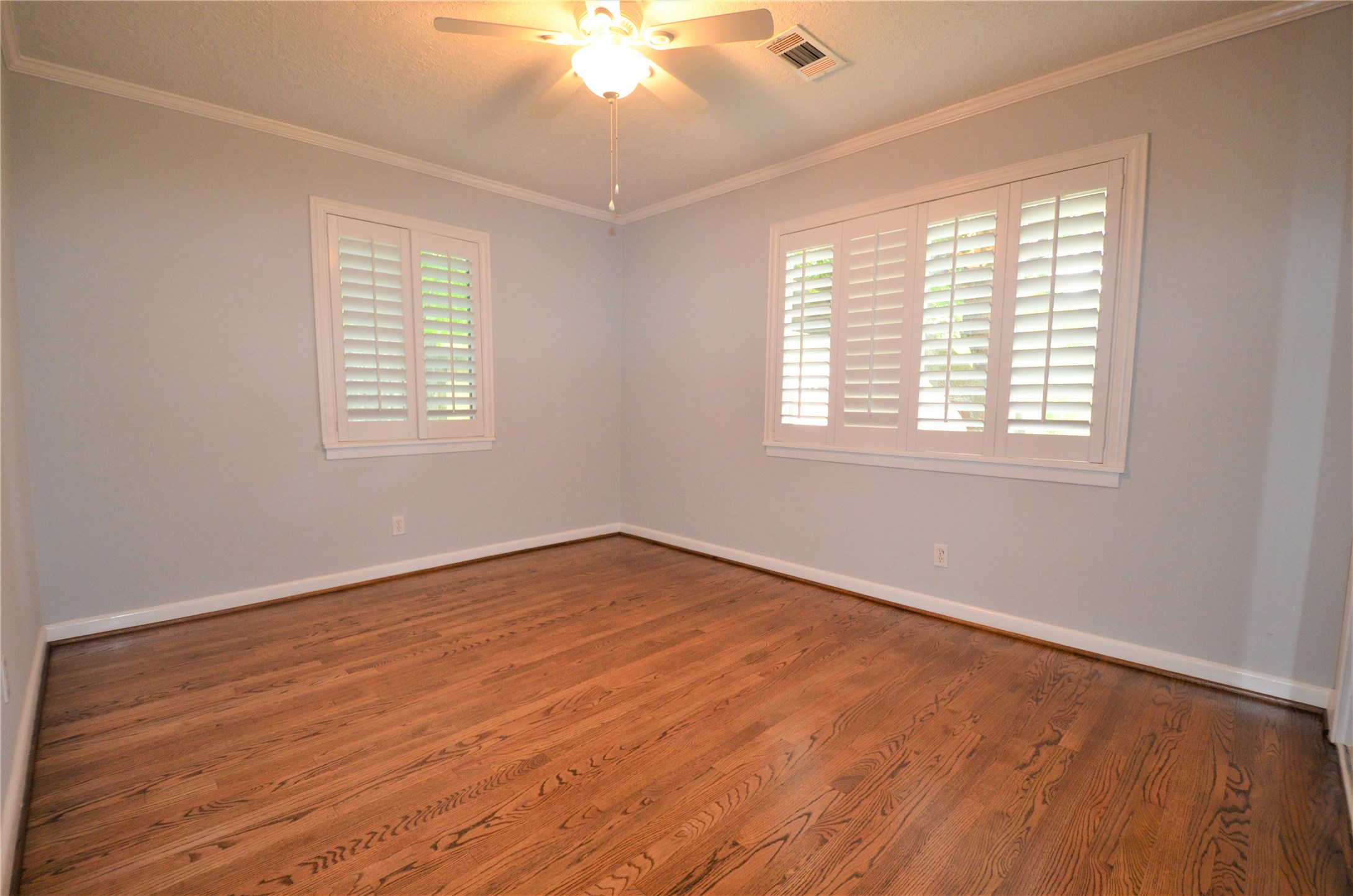 1902 Coulcrest Drive Houston, TX 77055 - Photo 12 of 27 a view of an empty room with wooden floor and a window