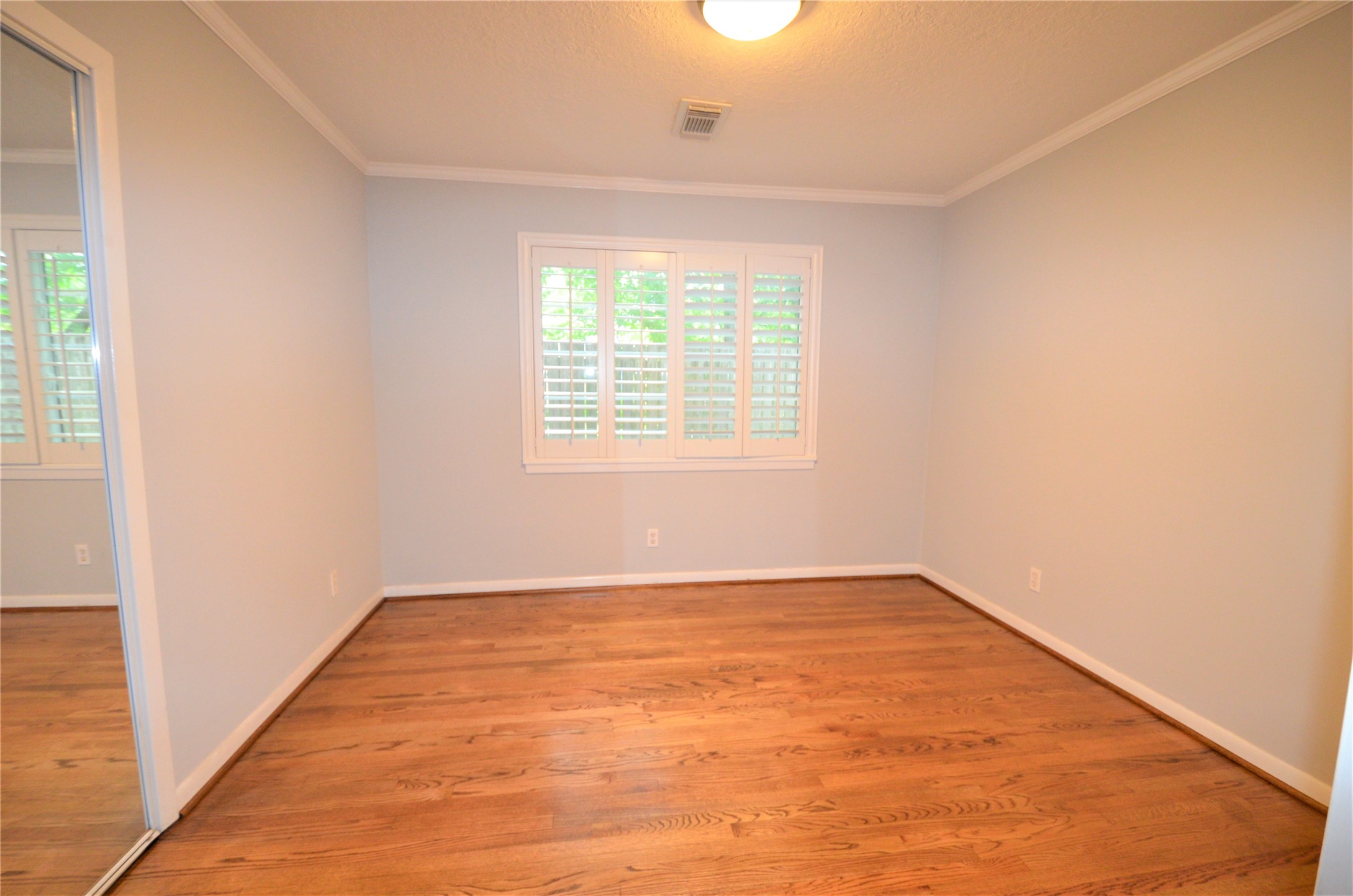 1902 Coulcrest Drive Houston, TX 77055 - Photo 13 of 27 an empty room with wooden floor and windows