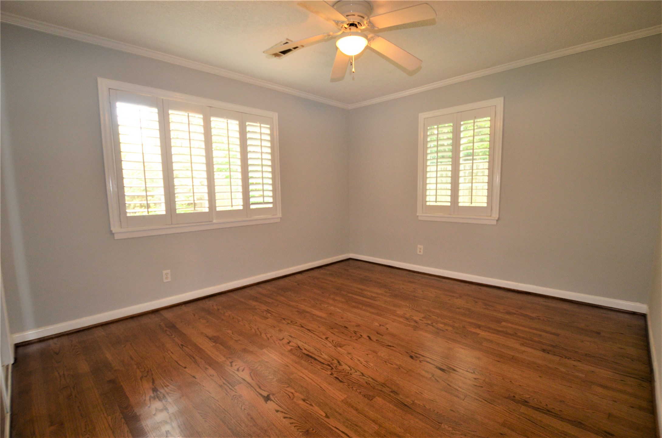 1902 Coulcrest Drive Houston, TX 77055 - Photo 16 of 27 a view of an empty room with wooden floor and a window