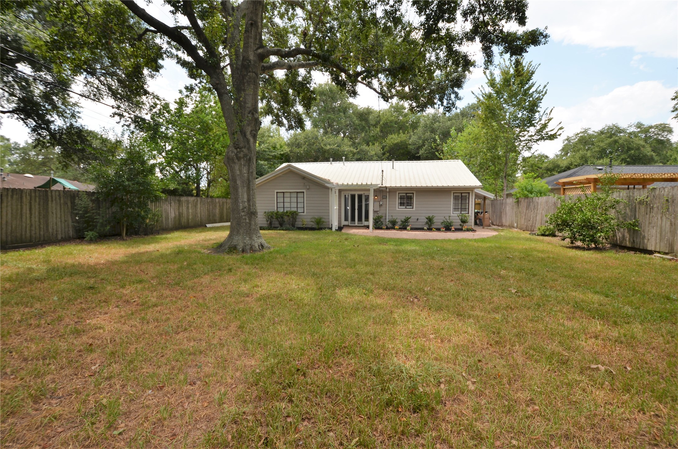 1902 Coulcrest Drive Houston, TX 77055 - Photo 17 of 27 a view of a house with a yard and sitting area