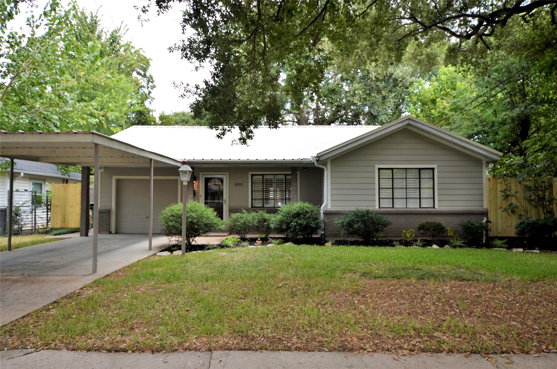 1902 Coulcrest Drive Houston, TX 77055 - Photo 2 of 27 a front view of a house with a yard and trees