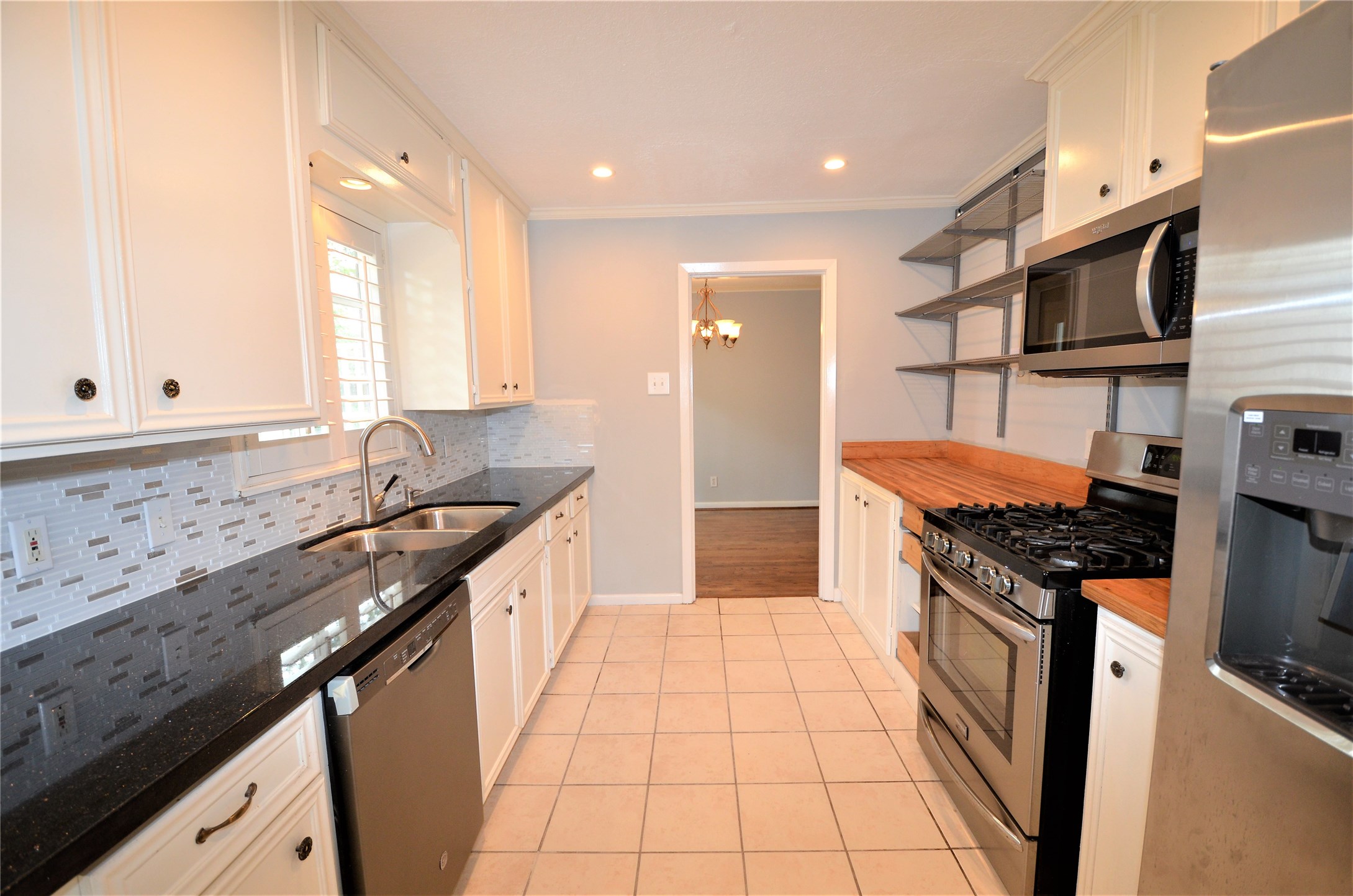 1902 Coulcrest Drive Houston, TX 77055 - Photo 7 of 27 a kitchen with stainless steel appliances granite countertop a sink stove and refrigerator
