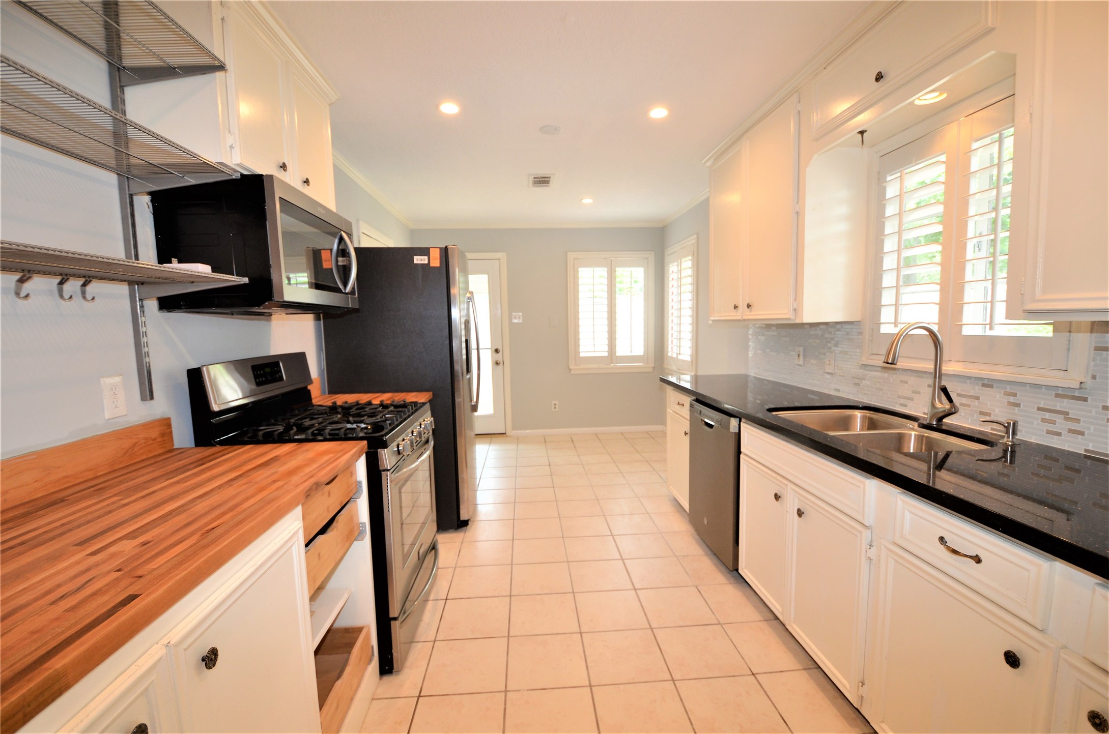 1902 Coulcrest Drive Houston, TX 77055 - Photo 10 of 27 a kitchen with stainless steel appliances granite countertop a sink and a stove