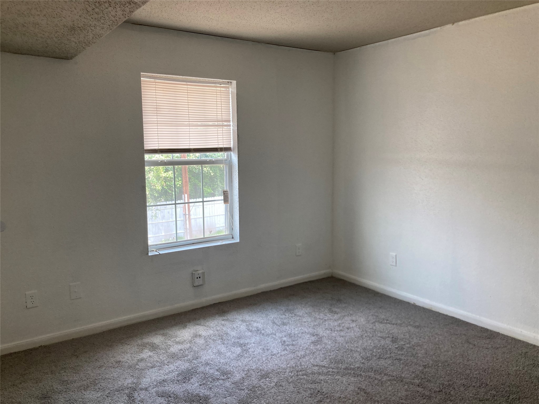 7201 Hallshire Drive, Unit 235 Houston, TX 77016 - Photo 7 of 10 an empty room with a window