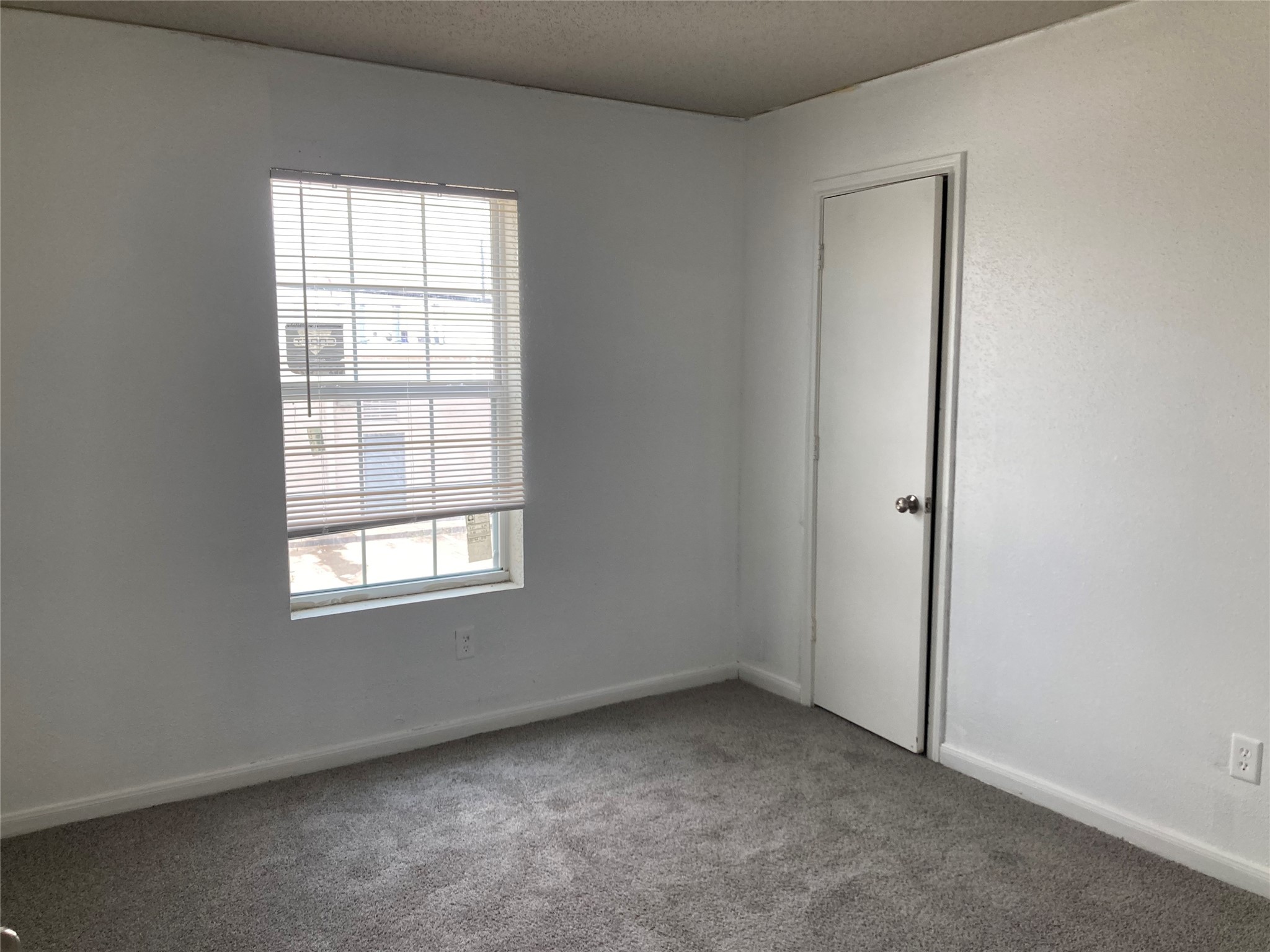 7201 Hallshire Drive, Unit 235 Houston, TX 77016 - Photo 8 of 10 an empty room with windows