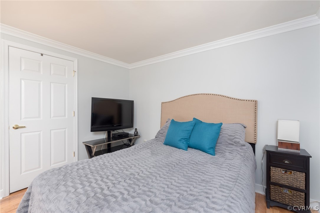 6424 Husting Road Chesterfield, VA 23832 - Photo 9 of 16 a bedroom with a bed and a flat tv screen on a dresser