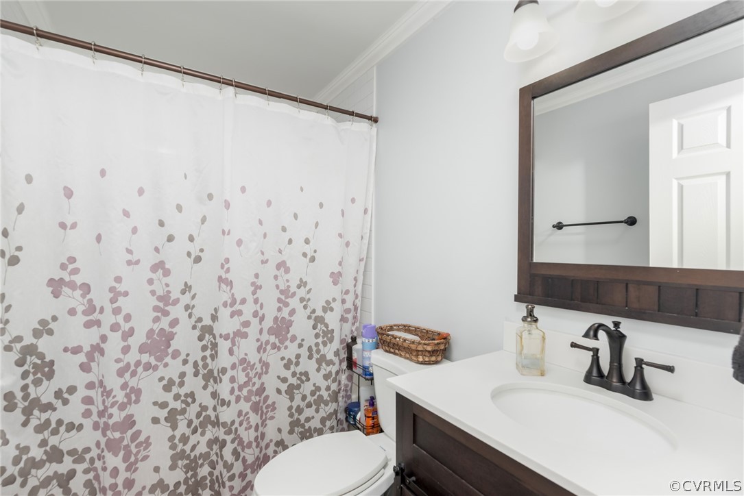 6424 Husting Road Chesterfield, VA 23832 - Photo 10 of 16 a bathroom with a sink a toilet and shower curtain