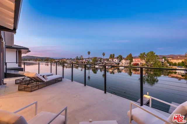 a front view of a house with swimming pool having outdoor seating