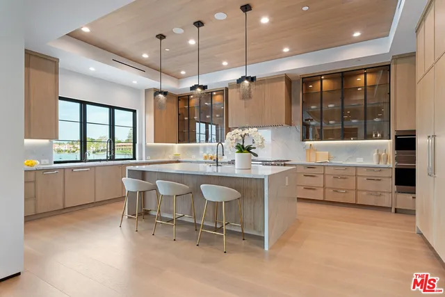 a spacious bedroom with a large bed and a large window