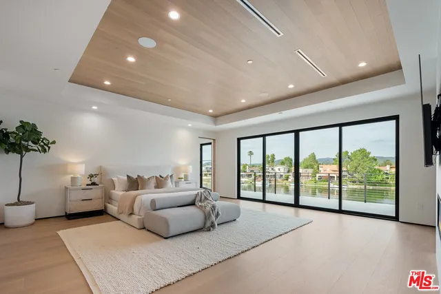 a large white kitchen with a large window