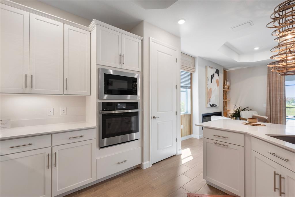 7157 Inlet Isles Lakewood Ranch, FL 34202 - Photo 7 of 26 a kitchen with white cabinets and white appliances