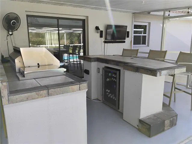 a living room with granite countertop furniture and flat screen tv