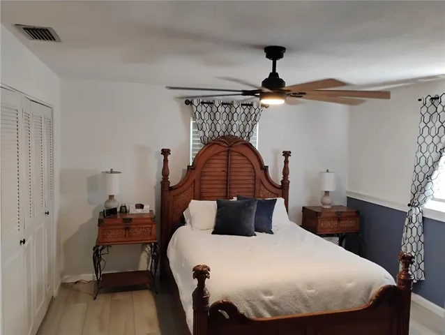 a bedroom with a bed and wooden floor