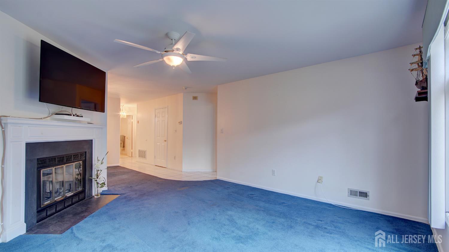 40 B Rutland Lane Monroe Township, NJ 08831 - Photo 12 of 31 a view of empty room with fireplace and flat screen tv