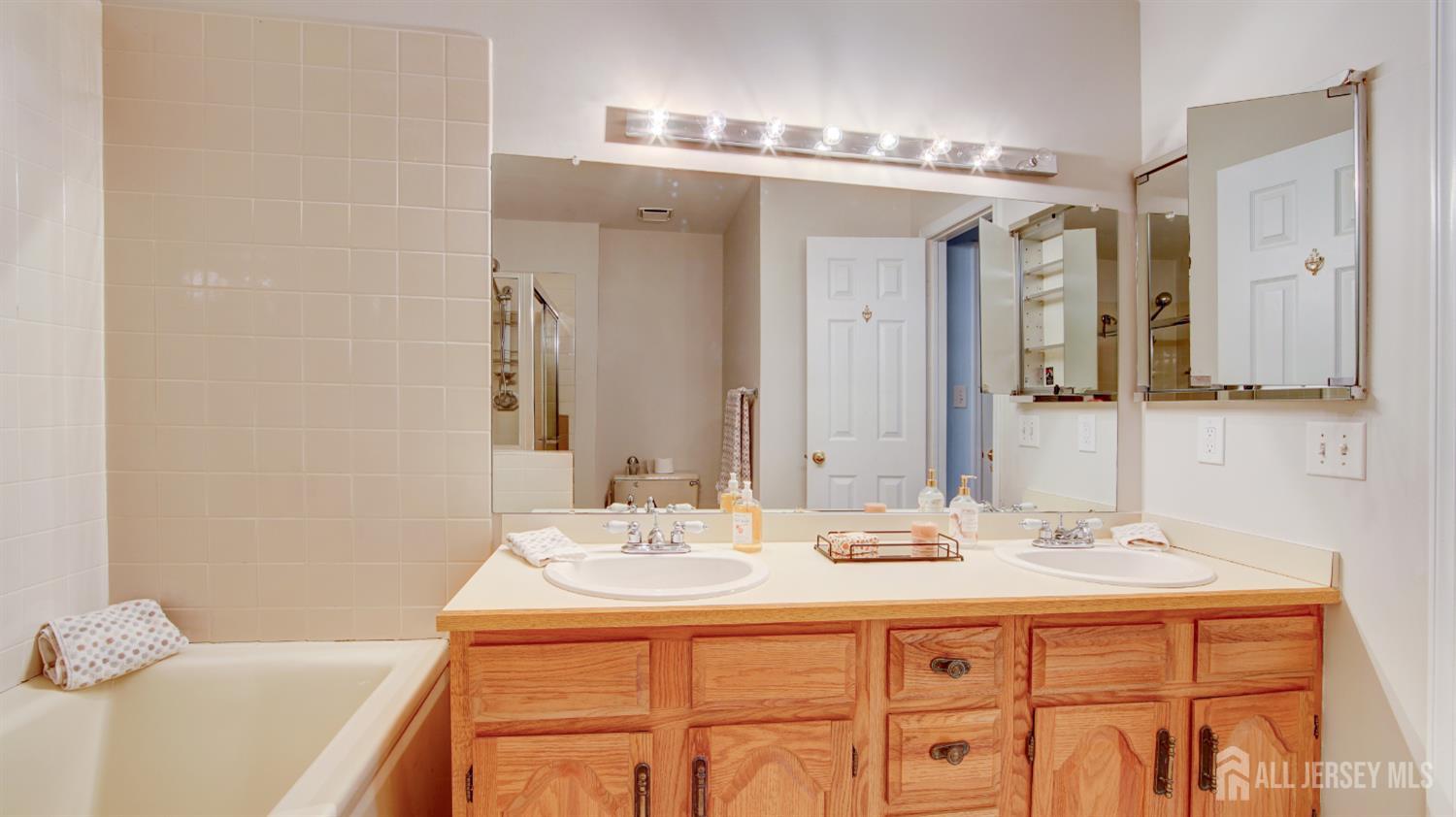 40 B Rutland Lane Monroe Township, NJ 08831 - Photo 17 of 31 a bathroom with a sink double vanity and a mirror