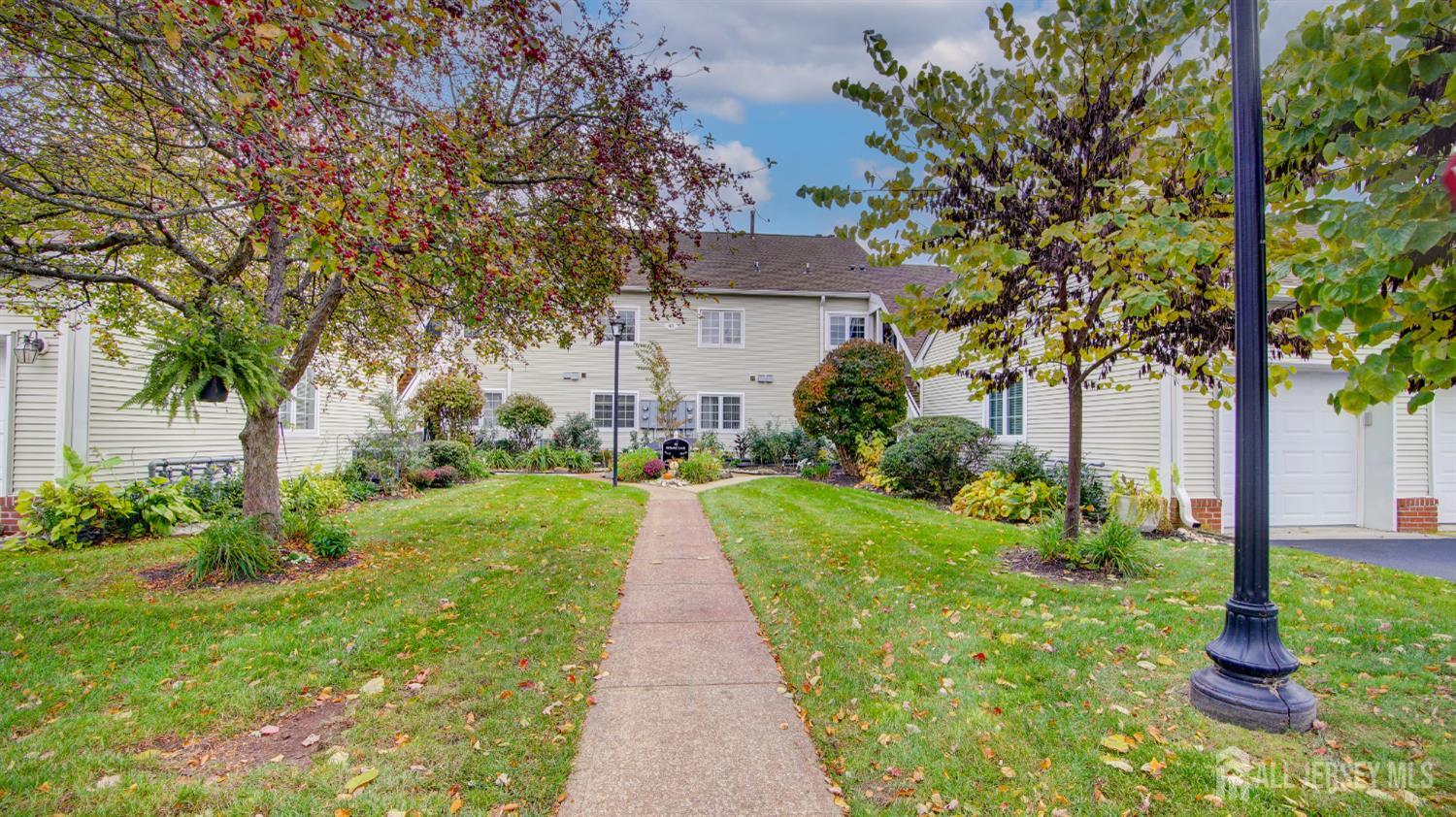 40 B Rutland Lane Monroe Township, NJ 08831 - Photo 20 of 31 a front view of a house with a yard and fountain