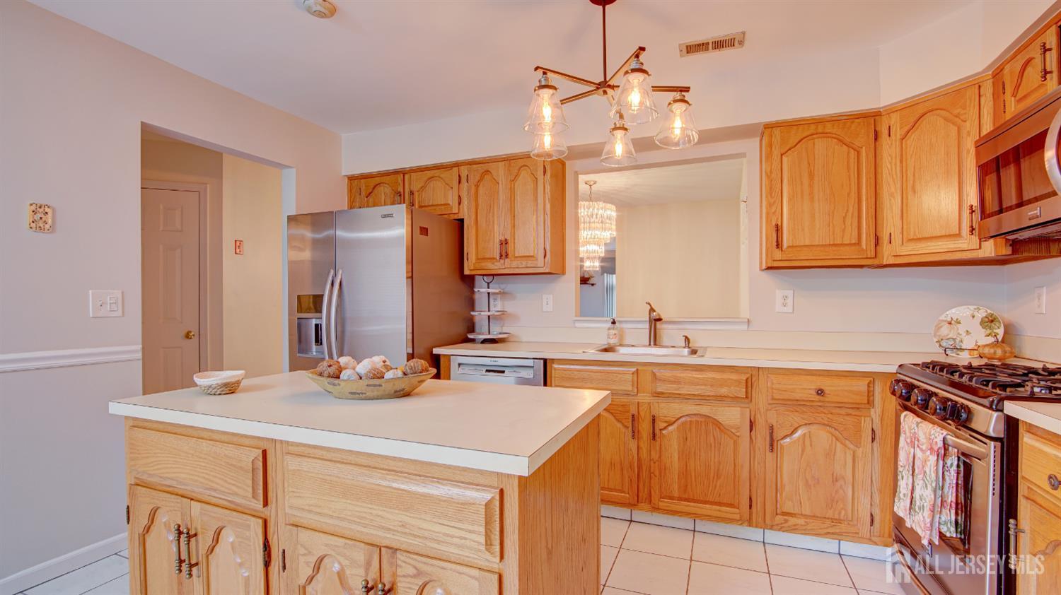 40 B Rutland Lane Monroe Township, NJ 08831 - Photo 2 of 31 a kitchen with stainless steel appliances granite countertop a sink stove and refrigerator