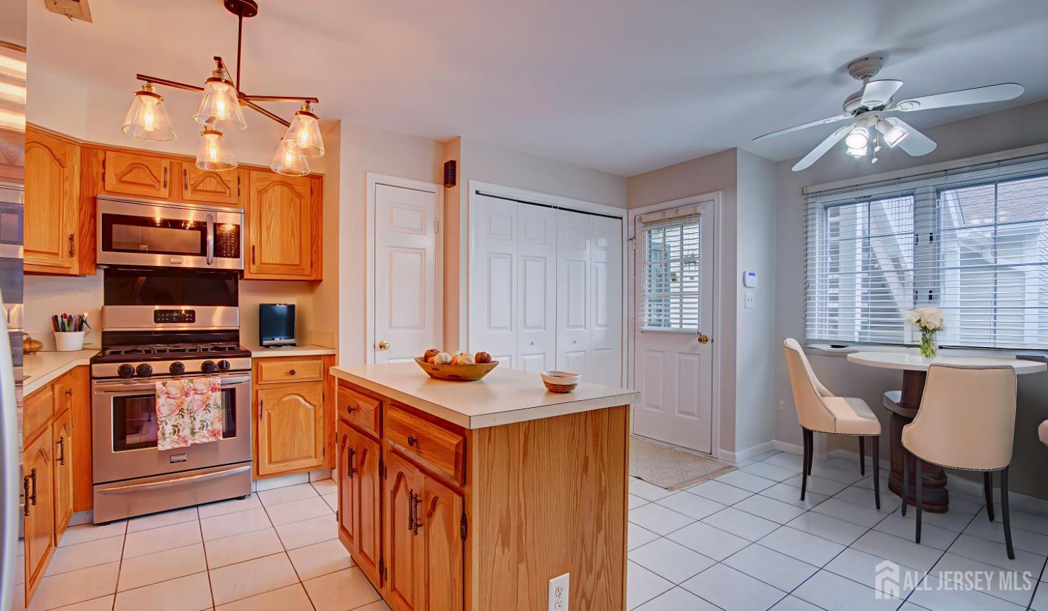 40 B Rutland Lane Monroe Township, NJ 08831 - Photo 26 of 31 a kitchen with stainless steel appliances a stove center island and a refrigerator