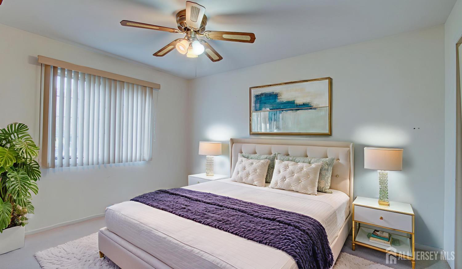 40 B Rutland Lane Monroe Township, NJ 08831 - Photo 28 of 31 a bedroom with a large bed and a chandelier