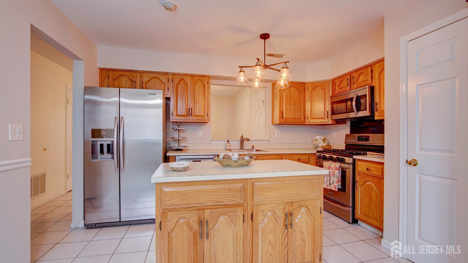 40 B Rutland Lane Monroe Township, NJ 08831 - Photo 4 of 31 a kitchen with stainless steel appliances granite countertop a sink a stove a refrigerator and cabinets