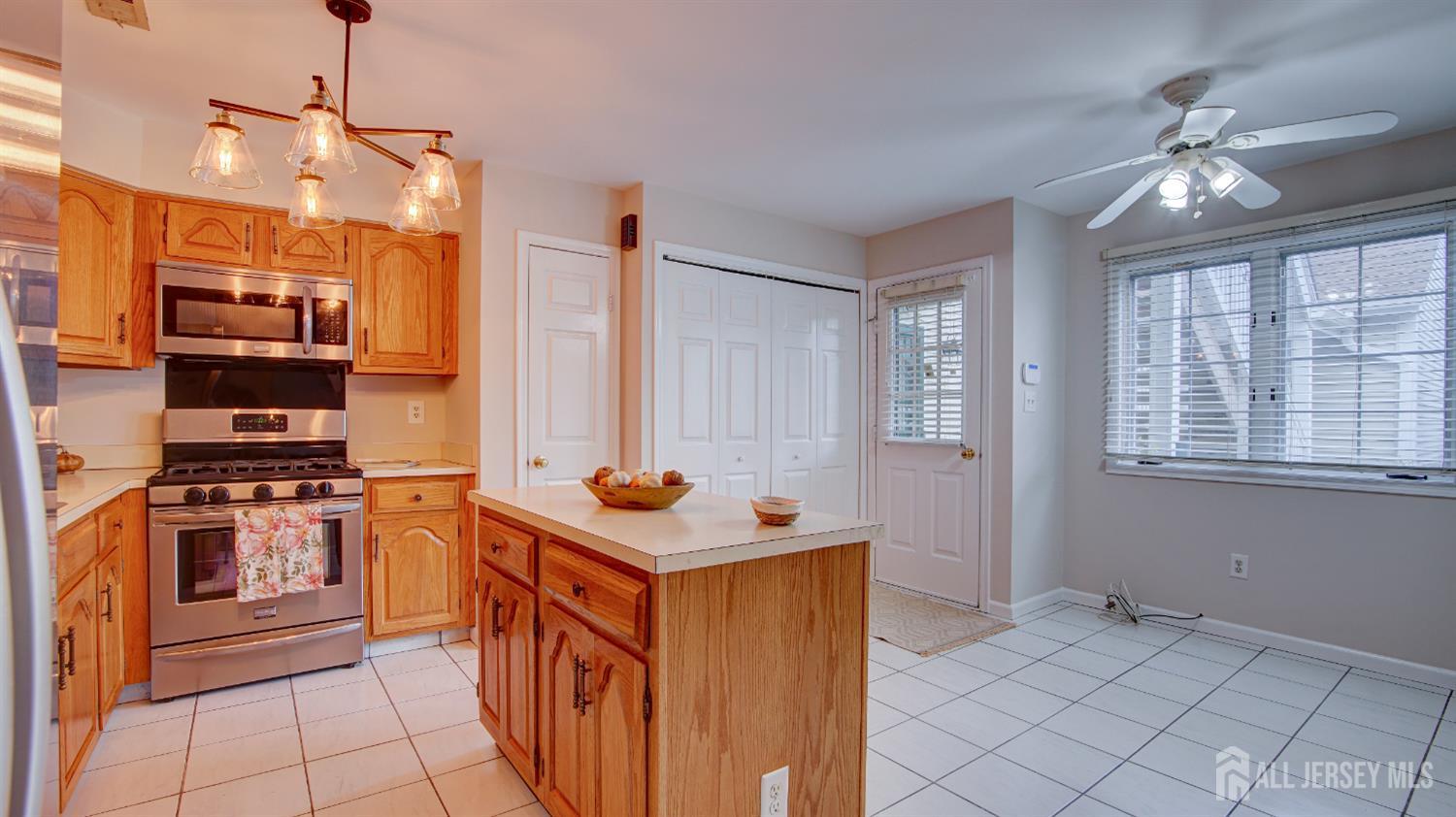 40 B Rutland Lane Monroe Township, NJ 08831 - Photo 5 of 31 a kitchen with stainless steel appliances a stove a sink and a refrigerator