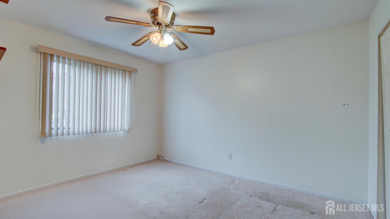 40 B Rutland Lane Monroe Township, NJ 08831 - Photo 6 of 31 an empty room with windows and fan
