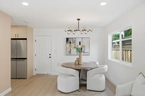 a view of a dining room with furniture window and outside view