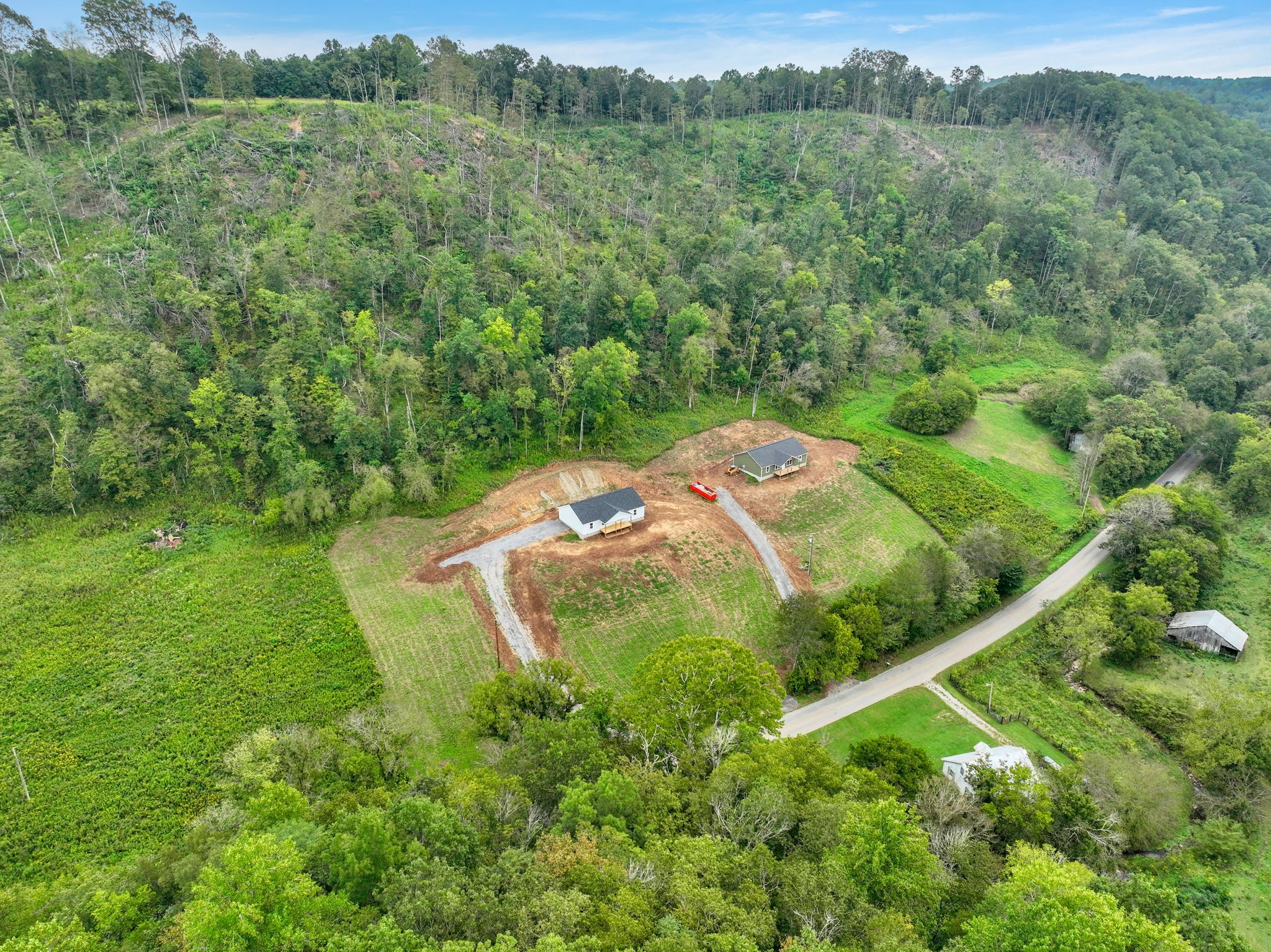 502 Difficult Road Pleasant Shade, TN 37145 - Photo 10 of 18 an aerial view of a houses with a lush green hillside