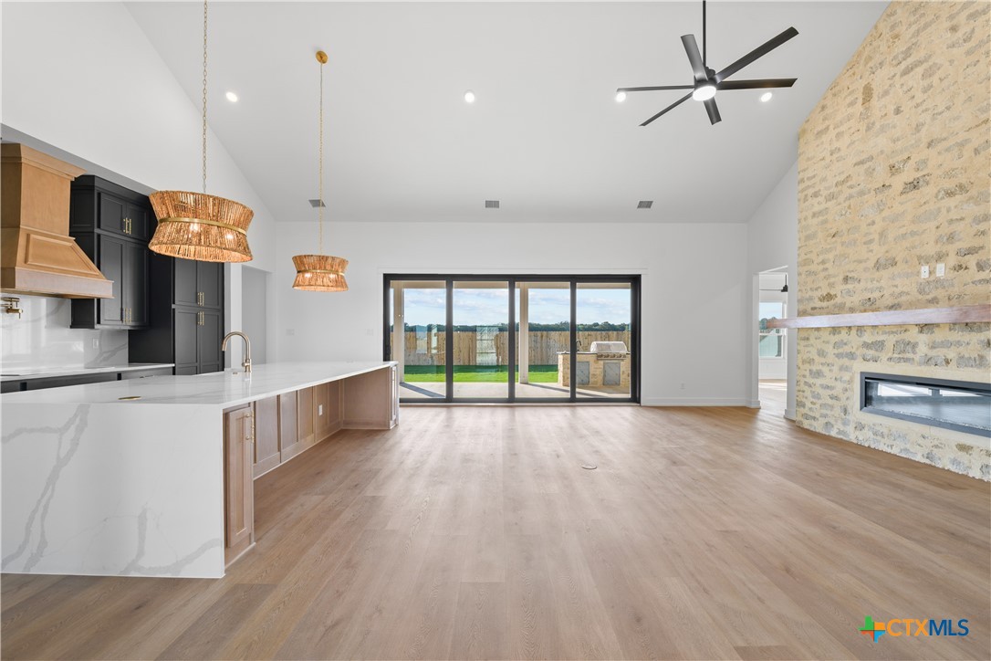 6830 Lacey Oak Road Salado, TX 76571 - Photo 11 of 34 a view of an empty room with window and wooden floor