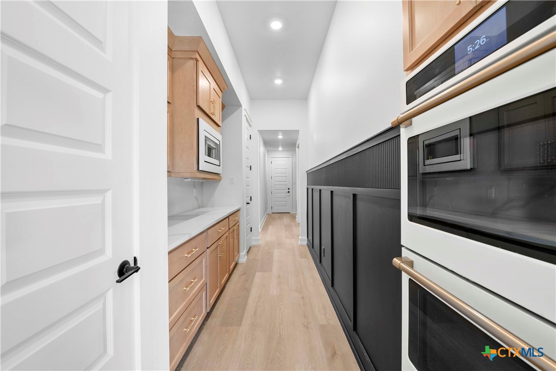 6830 Lacey Oak Road Salado, TX 76571 - Photo 14 of 34 a kitchen with stainless steel appliances granite countertop a refrigerator and a stove