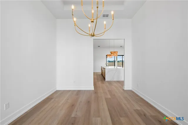a view of a hallway view with wooden floor and staircase