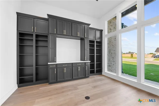 a kitchen with a cabinets and chandelier