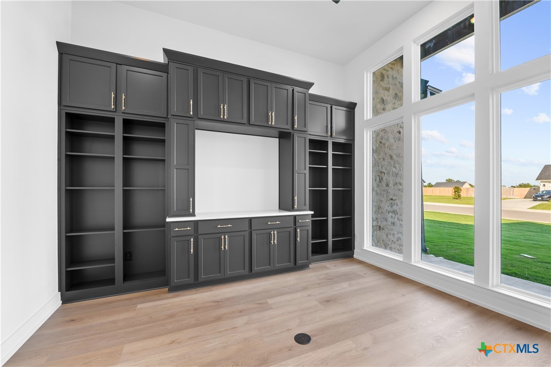6830 Lacey Oak Road Salado, TX 76571 - Photo 17 of 34 a kitchen with a cabinets and chandelier