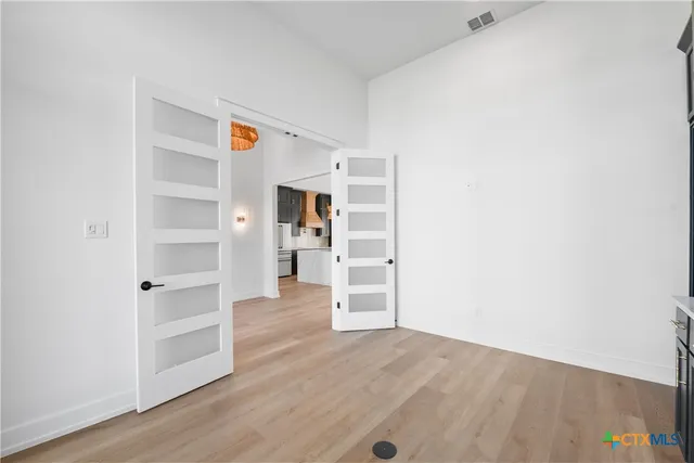 a view of a room with wooden floor and closet