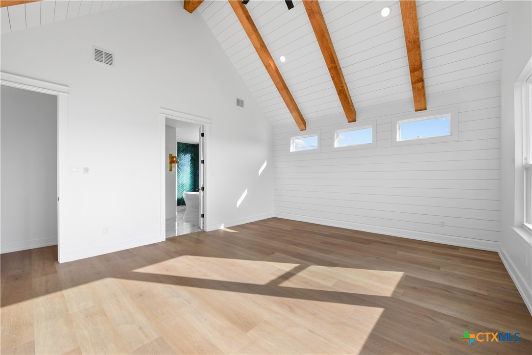 6830 Lacey Oak Road Salado, TX 76571 - Photo 20 of 34 a bedroom with a bed and hardwood floor