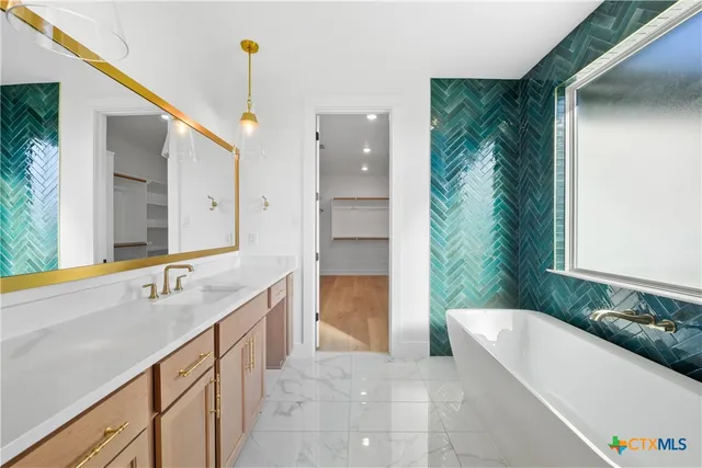 a bath room with a sink and a large mirror