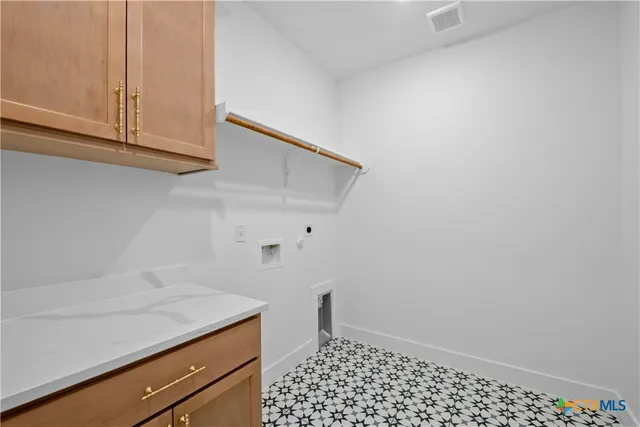 a room with a sink and cabinets