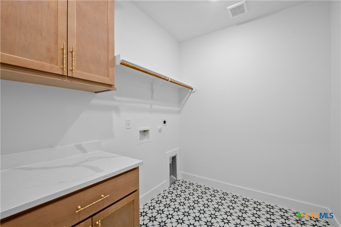 6830 Lacey Oak Road Salado, TX 76571 - Photo 25 of 34 a room with a sink and cabinets