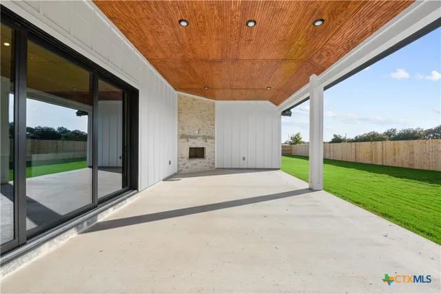 a view of a patio with yard and a garage