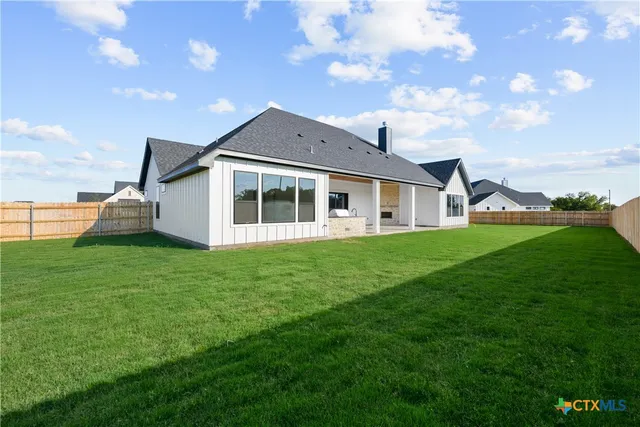 a view of an house with backyard porch and garden
