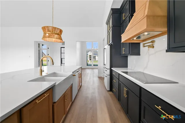 a kitchen with a sink and a stove top oven