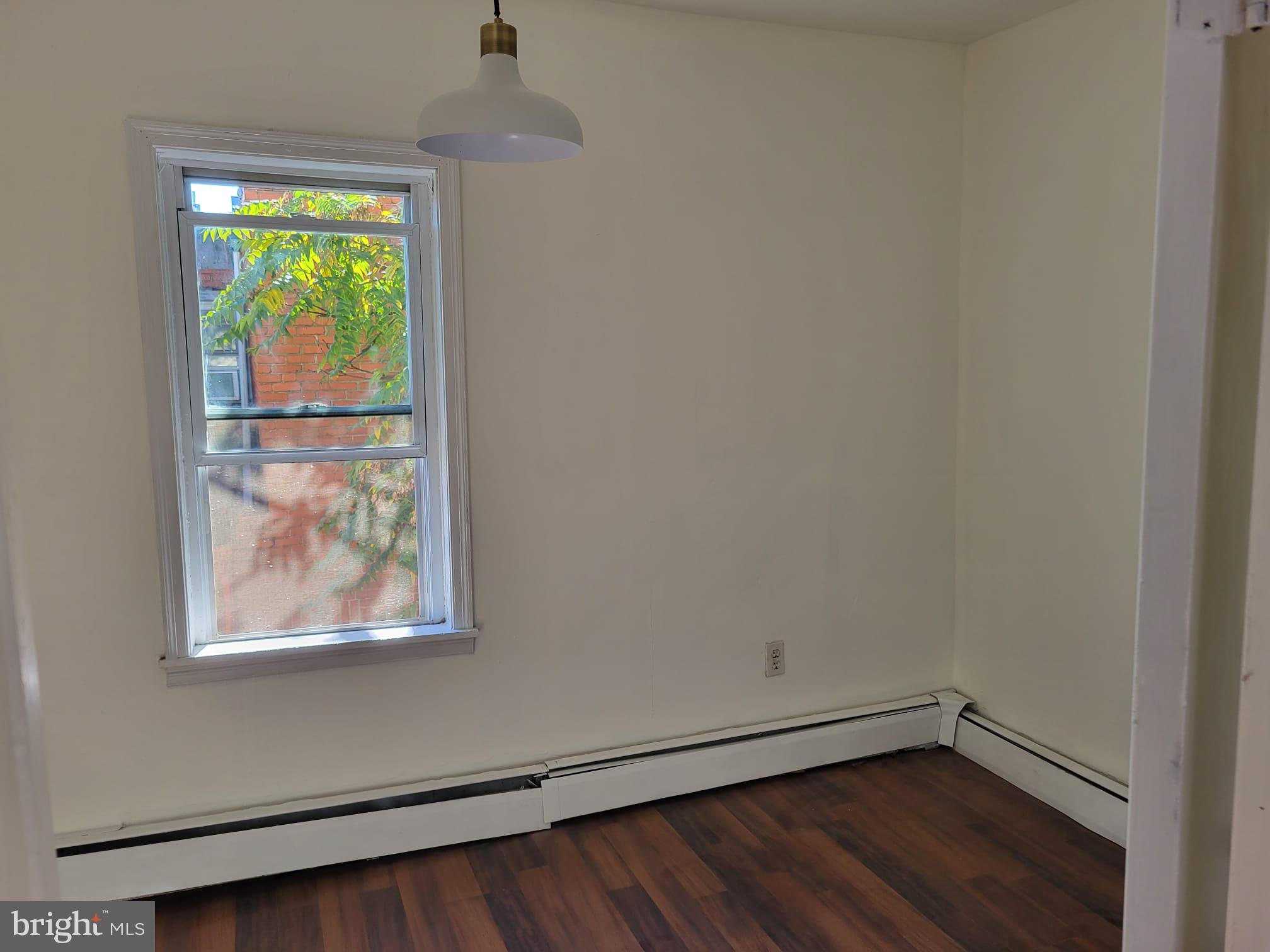 616 Tasker Street, Unit 2 Philadelphia, PA 19148 - Photo 9 of 22 a view of a small space with wooden floor and a window
