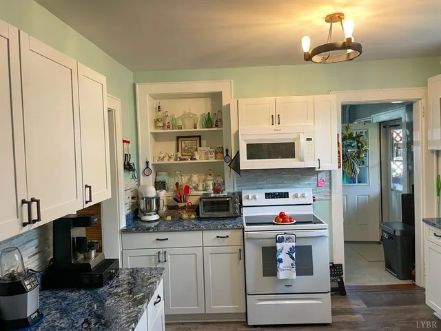 a kitchen with stainless steel appliances granite countertop a stove and a refrigerator