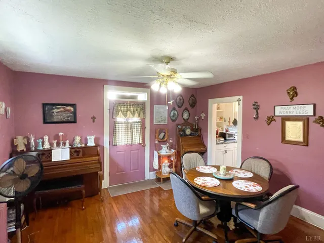 a dining room with furniture and wooden floor