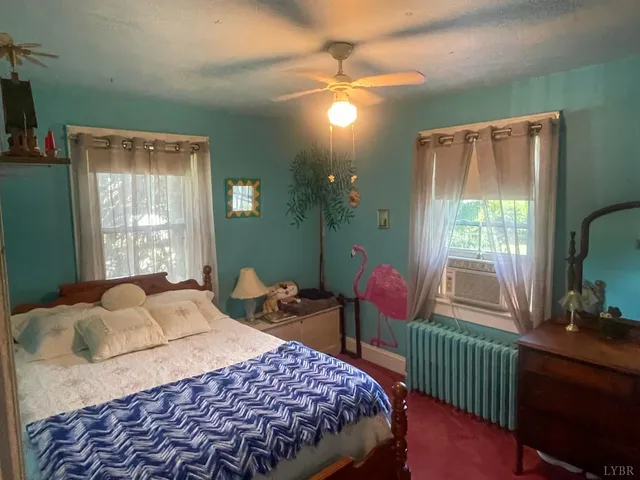 a bedroom with double bed and a window