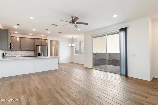 a view of a kitchen with wooden floor and a window
